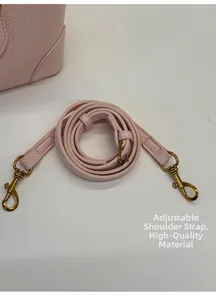 Detail of adjustable light pink pebbled leather strap with vintage gold metal hooks