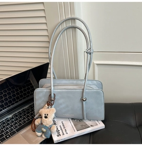 Light blue rectangular leather bag with fashion text and cute teddy bear pendant