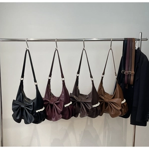 Detail view of large bow hobo bags in black, burgundy, coffee, and tan with lace trim