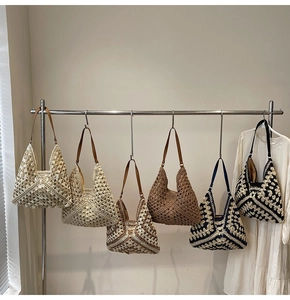 Detail showing various colors and woven textures of handmade crochet shoulder bags