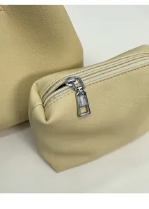 Detailed close-up of beige leather texture and silver zipper on the bucket bag set