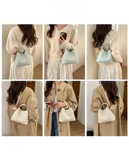 Minimalist bucket bag styled with beige knitwear and a cute teddy bear charm detail