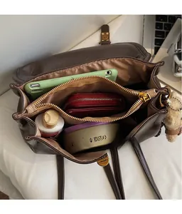 Detail view of the large capacity interior compartments of the vintage brown backpack
