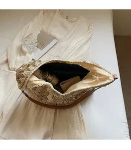 Interior view showing the spacious capacity of this beige woven straw tote with leather strap