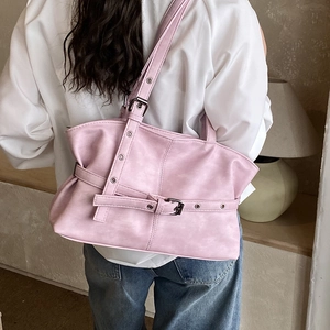 Détail du sac cabas en similicuir rose clair avec boucles élégantes et œillets métalliques