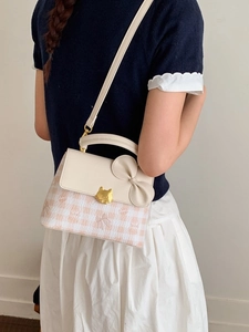 White and orange plaid crossbody bag with a large bow and a golden cat lock detail