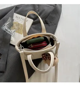 Top view of beige lychee leather bucket bag showing interior space for wallet and phone