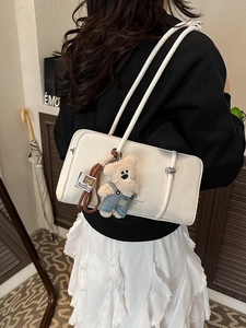 Minimalist white faux leather shoulder bag with a cute denim-clad plush bear charm