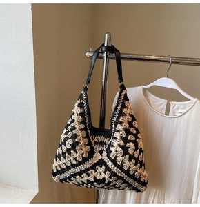 Detail of hand-woven tote bag with black and white geometric crochet patterns