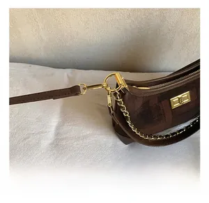 Detailed close-up of the vintage brown dumpling bag with premium gold metal chain hooks