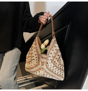 Detail of hand-woven crochet tote bag featuring geometric patterns and brown leather handles