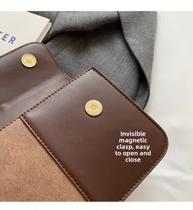 Detail of the high-quality magnetic closure and stitching on the brown leather bag