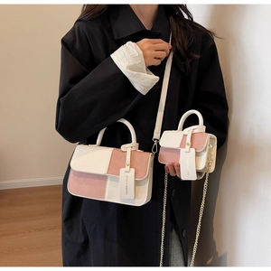 Detail view of contrast color crossbody bag set with chain strap and smooth leather texture