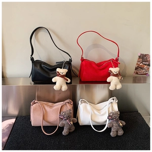 Detail view of stylish pillow bags in four colors with plaid bear charms and textures