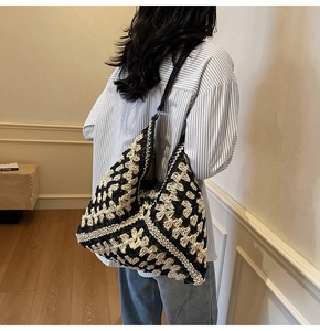 Detail of hand-woven geometric pattern on large black and white boho hobo bag