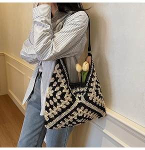 Detail of hand-crocheted tote bag showing geometric diamond patterns and leather strap