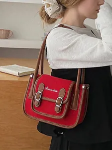 Sac bandoulière rétro en toile rouge avec garniture en cuir marron et lettrage blanc