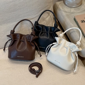 Three bucket bags with drawstring closure and knotted handles in brown, black, and beige