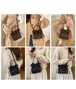 Style guide for pleated leather bucket bag in black and brown with drawstring detail