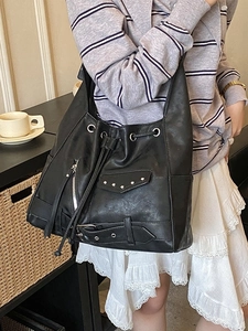 Retro punk style black motorcycle tote bag with silver rivets and leather tassels for women