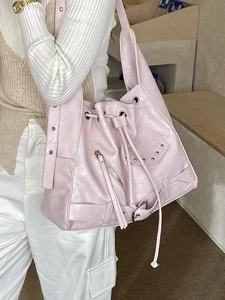 Pink punk tote bag with silver rivets and zippers shown on model for street style