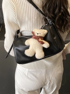 Minimalist black lychee texture pillow bag with cute bear charm and adjustable strap