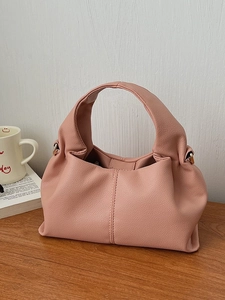Fashionable dusty rose cloud handbag with soft pebbled texture and top handle