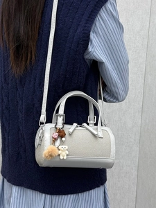 Fashionable cylinder crossbody bag in grey woven texture with cute bear charm and handles