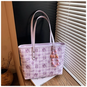 Detail showing lavender tote bag with bear patterns and pink beaded ribbon accessory