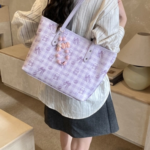 Detail of purple checkerboard tote bag with cute cartoon bears and pink beaded charms