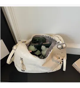 Detail view of cream tote bag with large capacity storage and striped lining