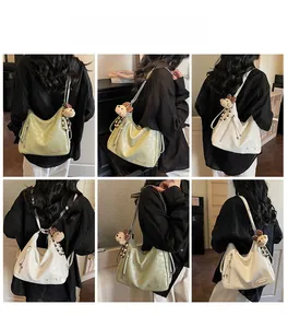 Detailed views of the large capacity hobo tote bag in sage green and creamy white leather