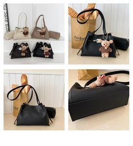 Detail showing high-quality lychee pattern leather and retro metal lock of the handbag