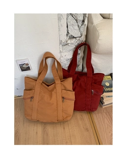 Λεπτομέρεια τσάντας canvas tote με πλαϊνές τσέπες με φερμουάρ και ανθεκτικές ραφές