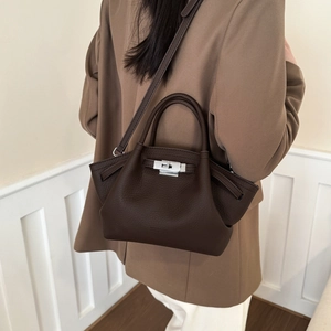 Close-up of caramel lychee grain leather bucket bag with silver metal swivel lock