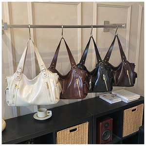 Detail view of large retro leather tote bags in four classic colors with gold hardware