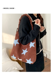 Brown suede tote bag featuring light blue star patches and ruffled shoulder strap detail