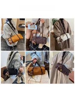 Detail view of multi-color suede hobo bags with long straps and mini charm accents