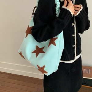 Detail of light blue star pattern tote bag with ruched handle and spacious interior