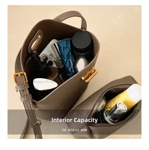 Top view of brown lychee leather bucket bag showing interior storage capacity and small pouch