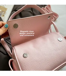Close-up of pink leather handbag showing secure double magnetic snap closure design
