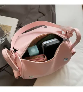 Detail view of pink lychee leather bag interior showing spacious storage for essentials