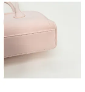 Close-up of pink leather baguette bag base with reinforced double stitching detail