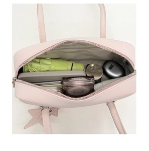 Detail view of pink baguette bag interior showing spacious main compartment and zip pocket
