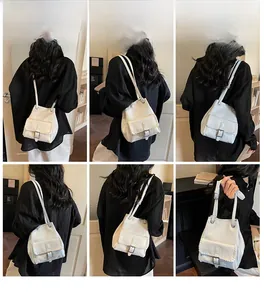 Détail du sac seau blanc avec bordures tressées et fermoir en métal sur le mannequin
