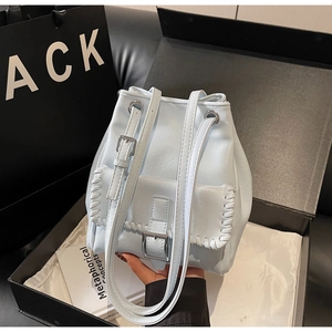 Vue détaillée du sac seau en cuir bleu clair avec des points de couture blancs tressés