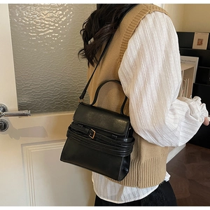 Sac sous le bras minimaliste en cuir noir mat avec boucle décorative et bandoulière