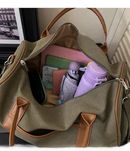 Detail view of the spacious interior of military green canvas travel bag with accessories