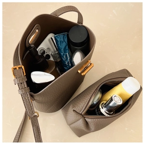 Top view of leather bucket bag and pouch showing spacious interior for essentials