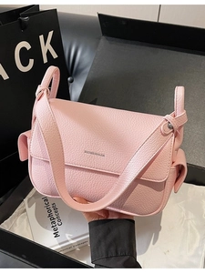 Pink lychee grain leather crossbody bag with minimalist flap design and shoulder strap